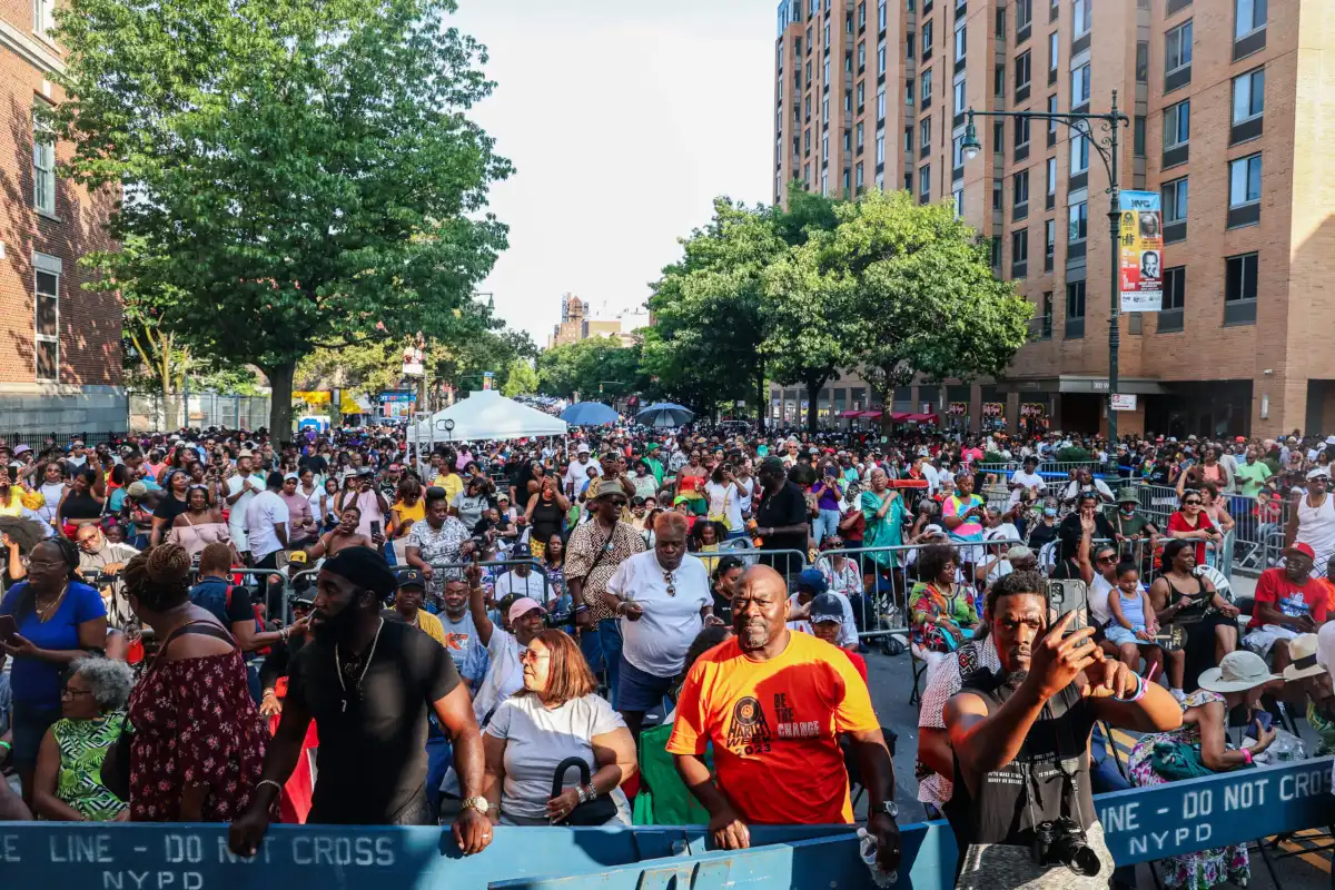 Vibrant street festival in Harlem with colorful vendor stalls and diverse community celebration